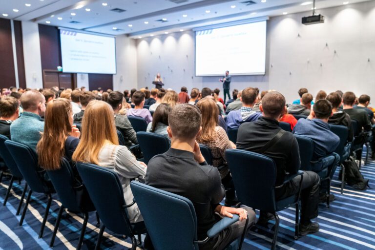 Image of a conference that takes place in a large conference room, workshop for young professionals, training in a large conference room, adult training